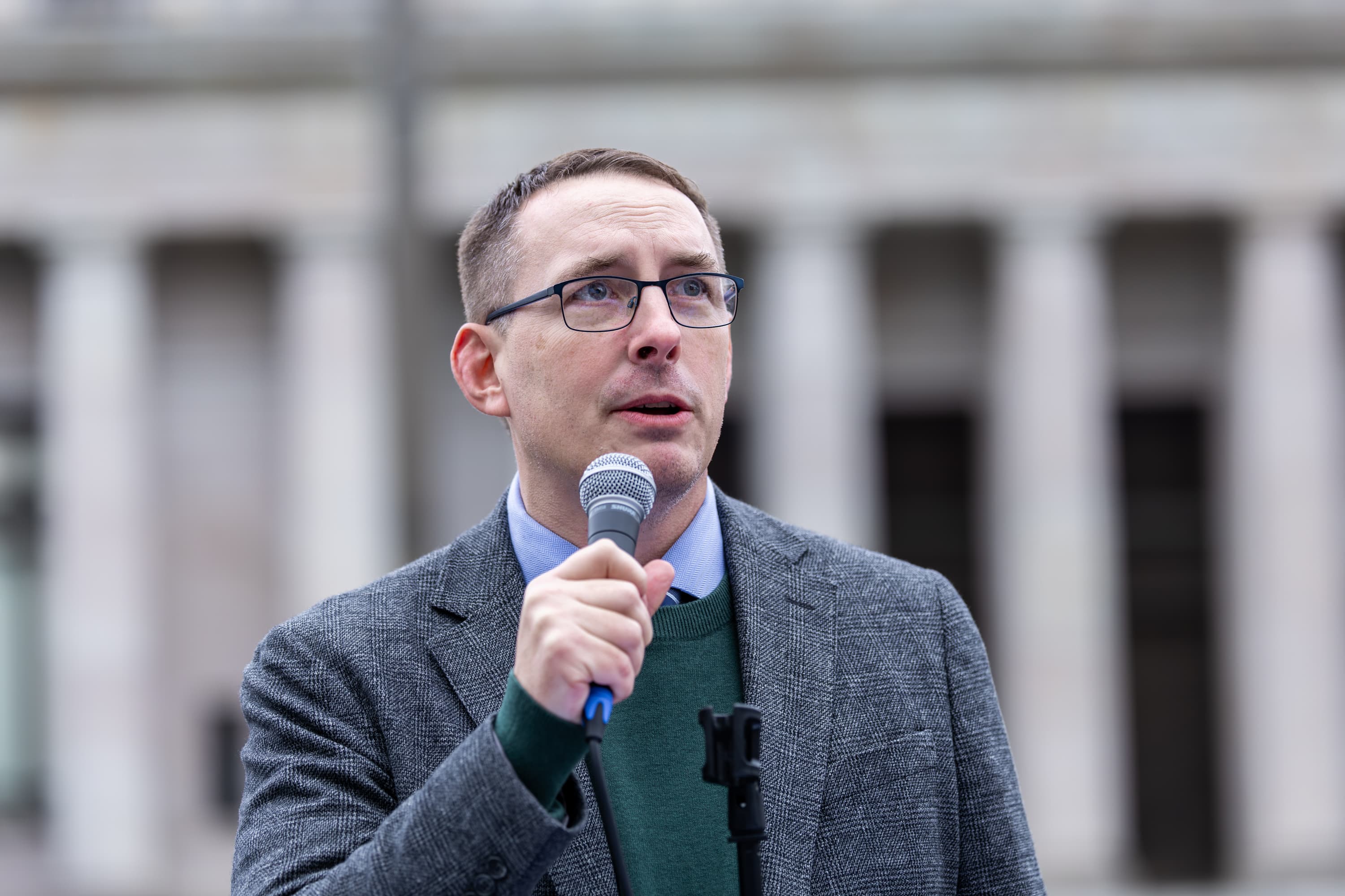 Joshua Penner speaking with a microphone